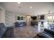 Gathering room with brick accent wall offers a comfortable living area adjacent to the kitchen at 340 Autumn Palace Ct, Las Vegas, NV 89144