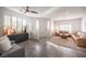 Inviting living room with shuttered windows, modern decor, and tile flooring, offering a blend of comfort and style at 340 Autumn Palace Ct, Las Vegas, NV 89144