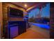 Outdoor entertainment area with TV, mini-fridge, and view of the pool is perfect for entertaining at 340 Autumn Palace Ct, Las Vegas, NV 89144