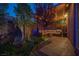 Cozy backyard patio features a custom water feature, seating area, and ambient lighting at 340 Autumn Palace Ct, Las Vegas, NV 89144