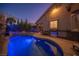 Beautiful backyard pool with a rock waterfall feature, built-in grill, and ample patio space at 340 Autumn Palace Ct, Las Vegas, NV 89144