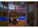 View of the lit pool and palm trees through open doors provides a resort-like feel at 340 Autumn Palace Ct, Las Vegas, NV 89144