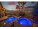 Backyard pool with a spa and illuminated by landscaping lights during twilight at 340 Autumn Palace Ct, Las Vegas, NV 89144