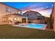 Home's backyard offers a private pool, spa, covered patio, and green space at 404 Lost Horizon Ave, Henderson, NV 89002