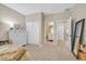 Serene bedroom with neutral decor, plush carpeting, and convenient access to the closet and ensuite bathroom at 404 Lost Horizon Ave, Henderson, NV 89002