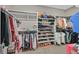 Organized walk-in closet filled with clothes, shoes, and accessories for storage at 404 Lost Horizon Ave, Henderson, NV 89002