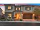 Charming two-story home showcasing a stone facade, tile roof, and inviting front porch at 404 Lost Horizon Ave, Henderson, NV 89002