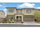 Charming two-story home featuring a stone facade, covered entry, and well-maintained landscaping at 404 Lost Horizon Ave, Henderson, NV 89002