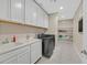 Spacious laundry room with washer, dryer, sink, and storage at 404 Lost Horizon Ave, Henderson, NV 89002