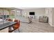 Bright living room featuring an open floor plan, stylish tile flooring, and a view of the backyard at 404 Lost Horizon Ave, Henderson, NV 89002