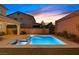 Sparkling pool and spa with a beautiful sunset view in a private backyard oasis at 404 Lost Horizon Ave, Henderson, NV 89002