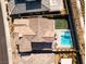 Aerial view of a tile roof home with a pool and patio, situated in a well-maintained neighborhood at 421 Malpaso St, Las Vegas, NV 89138