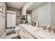 This bathroom has a white double vanity and a shower with a white curtain at 421 Malpaso St, Las Vegas, NV 89138