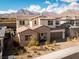 A beautiful two-story house with brick accents, a tile roof, a driveway, and mountain views at 421 Malpaso St, Las Vegas, NV 89138