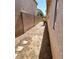 This backyard has a block wall, a small tree, and desert landscaping at 4718 Victoria Garden Ave, North Las Vegas, NV 89031