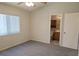 This bedroom has a ceiling fan, a large window and carpeted flooring at 4718 Victoria Garden Ave, North Las Vegas, NV 89031