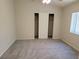 This bedroom has carpeted floors, a large window and a closet with sliding doors at 4718 Victoria Garden Ave, North Las Vegas, NV 89031