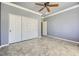This bedroom features neutral paint, a ceiling fan, and a large closet with paneled doors at 4750 Fiore Bella Blvd, Las Vegas, NV 89135