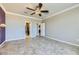 Comfortable bedroom with ceiling fan, tile floors, and neutral tones at 4750 Fiore Bella Blvd, Las Vegas, NV 89135