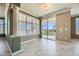 Bright living room featuring large windows, custom shutters, and tile floors at 4750 Fiore Bella Blvd, Las Vegas, NV 89135