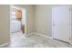 Mud room and indoor laundry area with door to garage, ceramic tile flooring, beige walls and wood cabinets at 4750 Fiore Bella Blvd, Las Vegas, NV 89135