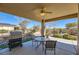 Outdoor patio with seating area, grill, and ceiling fan providing a relaxing atmosphere at 4750 Fiore Bella Blvd, Las Vegas, NV 89135