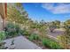 Landscaped backyard featuring desert plants, a patio area, and views of other homes in the neighborhood at 5008 Shoal Creek Cir, Las Vegas, NV 89113