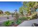 Landscaped backyard featuring a well-maintained garden and patio area with views of community landscape at 5008 Shoal Creek Cir, Las Vegas, NV 89113