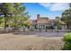 Beautiful backyard featuring mature trees, desert landscaping, and a covered patio at 5008 Shoal Creek Cir, Las Vegas, NV 89113