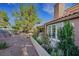 Well-maintained backyard featuring mature landscaping, a patio, and elegant access to the home at 5008 Shoal Creek Cir, Las Vegas, NV 89113