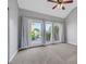 Bedroom with carpet, ceiling fan, and sliding doors opening to a small balcony at 5008 Shoal Creek Cir, Las Vegas, NV 89113