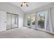 Bedroom with carpet, closet, ceiling fan, and sliding doors opening to a small balcony at 5008 Shoal Creek Cir, Las Vegas, NV 89113