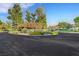 Beautiful community entrance with lush landscaping and decorative signage at 5008 Shoal Creek Cir, Las Vegas, NV 89113