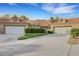 Charming home exterior with a well-manicured lawn, mature hedges, and a spacious two-car garage at 5008 Shoal Creek Cir, Las Vegas, NV 89113