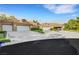 Charming home featuring multiple garages, desert landscaping, and a red tile roof at 5008 Shoal Creek Cir, Las Vegas, NV 89113