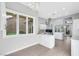 Bright kitchen features tile floors, white cabinets, stainless steel appliances, and large windows for natural light at 5008 Shoal Creek Cir, Las Vegas, NV 89113