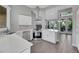 Modern kitchen with stainless steel appliances, island, and views to the living room and french doors at 5008 Shoal Creek Cir, Las Vegas, NV 89113