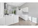 Bright kitchen featuring white cabinets, stainless steel appliances, light tile flooring, and recessed lighting at 5008 Shoal Creek Cir, Las Vegas, NV 89113