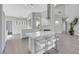 Bright, open-concept kitchen featuring a large island with seating, and modern stainless steel appliances at 5008 Shoal Creek Cir, Las Vegas, NV 89113