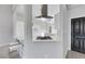Modern kitchen with stainless steel range, breakfast bar seating, and views into the other rooms of the home at 5008 Shoal Creek Cir, Las Vegas, NV 89113