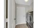 Laundry room showcasing side-by-side washer and dryer, gray walls, white trim, and tile flooring at 5008 Shoal Creek Cir, Las Vegas, NV 89113