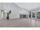 Open-concept living room with a fireplace, tile floors, and bright natural light from the patio doors at 5008 Shoal Creek Cir, Las Vegas, NV 89113
