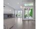 Spacious living room with fireplace, wood floors, high ceilings, chandelier, and French doors to the backyard at 5008 Shoal Creek Cir, Las Vegas, NV 89113