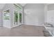 Bright living room featuring wood floors, high ceilings, elegant chandelier, and French doors to the outdoor space at 5008 Shoal Creek Cir, Las Vegas, NV 89113
