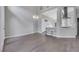 Bright, airy living space flowing into the kitchen, featuring light-colored tile floors and a modern chandelier at 5008 Shoal Creek Cir, Las Vegas, NV 89113