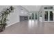 Bright living room featuring a fireplace, light-colored tile floors, and views of the back patio at 5008 Shoal Creek Cir, Las Vegas, NV 89113