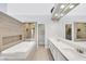 Bright bathroom featuring walk in shower, bathtub, and dual sinks at 5008 Shoal Creek Cir, Las Vegas, NV 89113