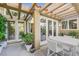 Beautiful covered patio with outdoor seating, stylish lighting, and access through glass doors and windows at 5008 Shoal Creek Cir, Las Vegas, NV 89113