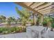 Covered outdoor patio with elegant seating and lush landscaping, perfect for relaxing or entertaining at 5008 Shoal Creek Cir, Las Vegas, NV 89113
