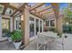 Cozy covered patio with seating, stylish lighting, and garden view through large windows and glass doors at 5008 Shoal Creek Cir, Las Vegas, NV 89113